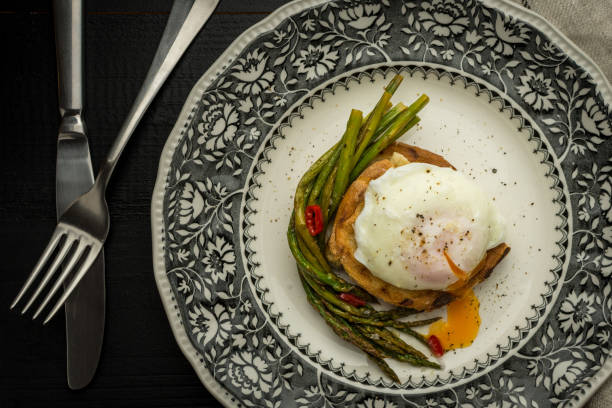 istock Poached Egg on Toasted Bread With Green Asparagus and Chili Peppers 963117346