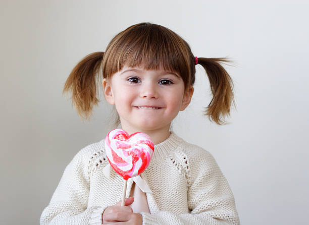 Girl and a lollipop stock photo