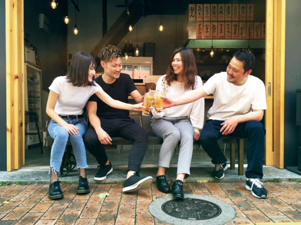 istock Group of young international friends drinking together 963120678