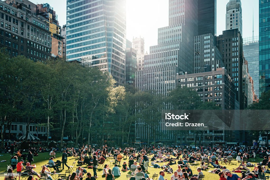 Bryant park near the Library in NYC crowded with people in the afternoon The most famous and fabulous city in the world - New York City as unique lifestyle, architecture and landmarks. Public Park Stock Photo