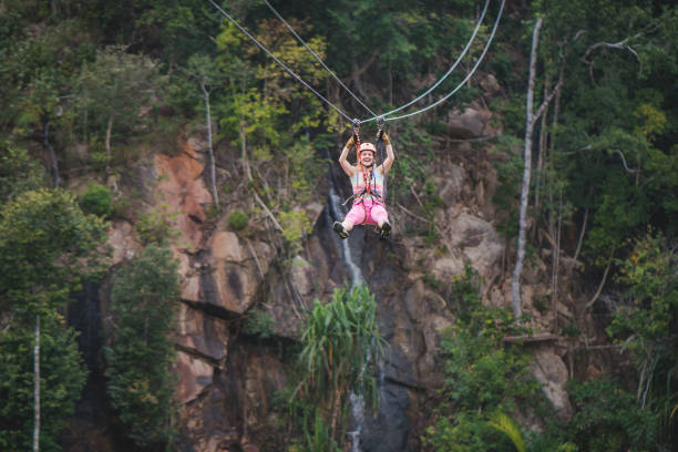 istock Cheerful woman having fun during canopy tour in the forest. 963121626