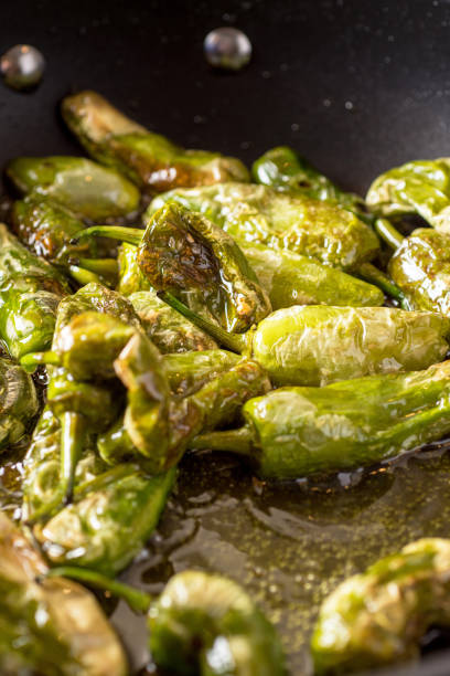 istock Preparing Green Padron Peppers in the Frying Pan 963122948