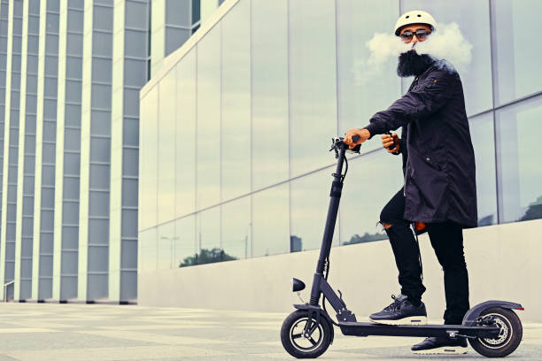 istock A man vaping and riding by electric scooter. 963123002