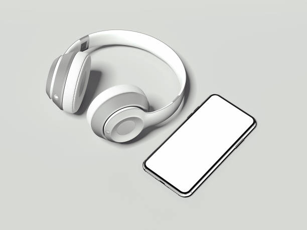 istock White headphones and phone with blank screen on light background, 3d renderinf 963126392
