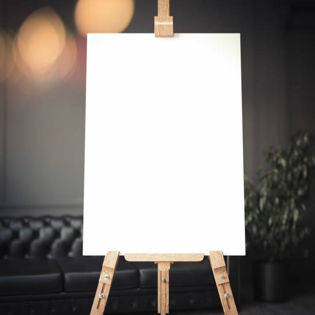 White easel stands next to dark wall and black sofa, 3d rendering White easel stands next to dark wall, black sofa and plant, 3d rendering easel stock pictures, royalty-free photos & images