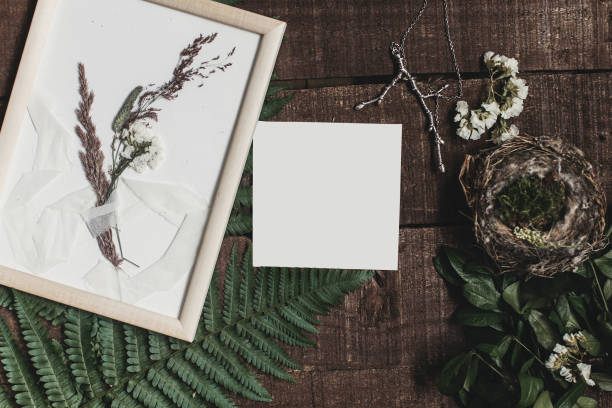 istock wedding invitation mock-up and rustic boutonniere under glass frame on wooden  background with fern leaves. rustic barn wedding concept. top view. flat lay, empty card 963126870
