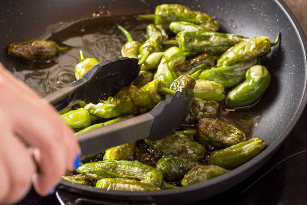 istock Preparing Green Padron Peppers in the Frying Pan 963127070