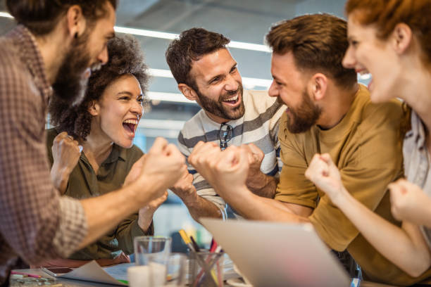 istock Joyful freelancers screaming while celebrating their business success in the office. 963127680