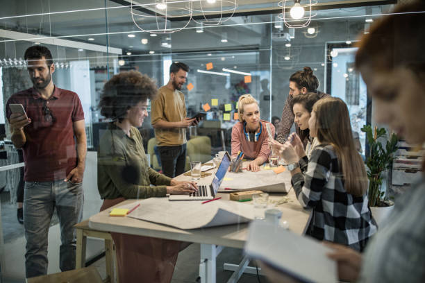istock Large group of young entrepreneurs working different things in the office. 963127974