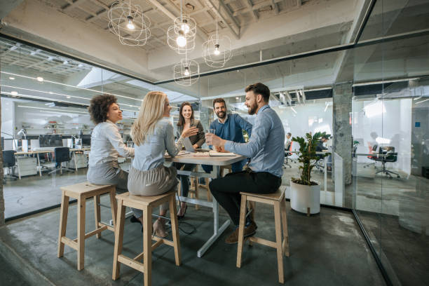 istock Happy business team talking on a meeting in the office. 963130176