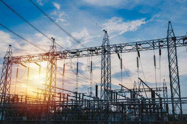 istock Sunset behind substation towers with blue sky 963130232