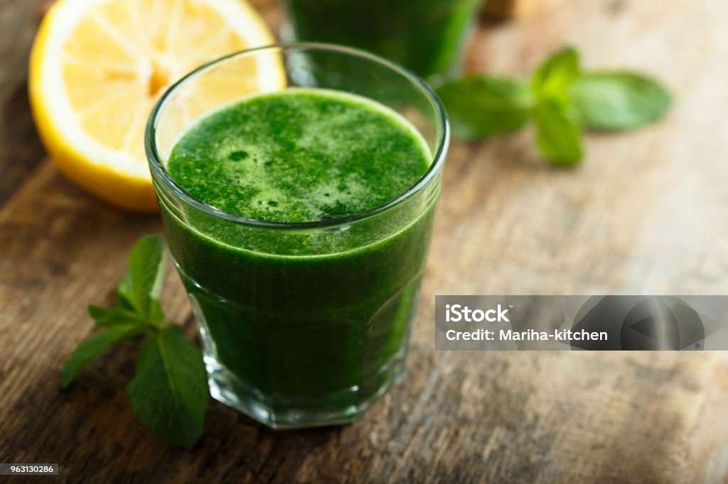 Healthy freshly made green smoothie Healthy freshly made green smoothie with spinach and kale Juice - Drink Stock Photo