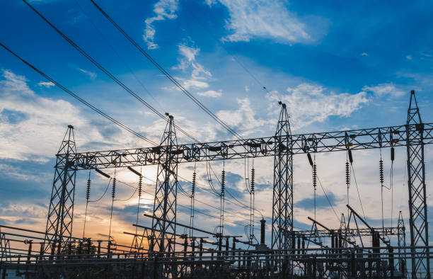 istock Sunset behind substation towers with blue sky 963130508