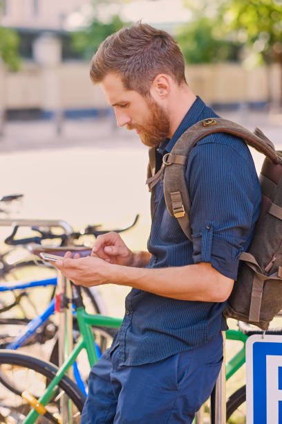 istock Bearded hipster male using smartphone outdoor. 963131020