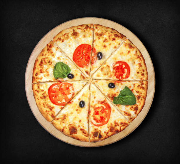 istock Margarita pizza on a black background. 963131570
