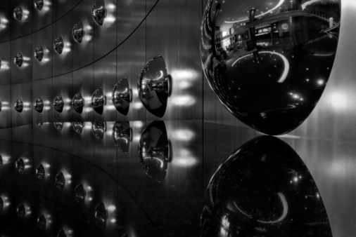 round mirrors reflecting the hotel lobby