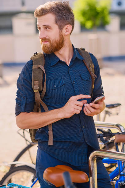 istock Bearded hipster male using smartphone outdoor. 963132184