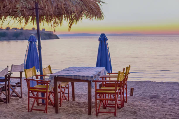 istock chairs and umbrella on the beach at sunset 963132332