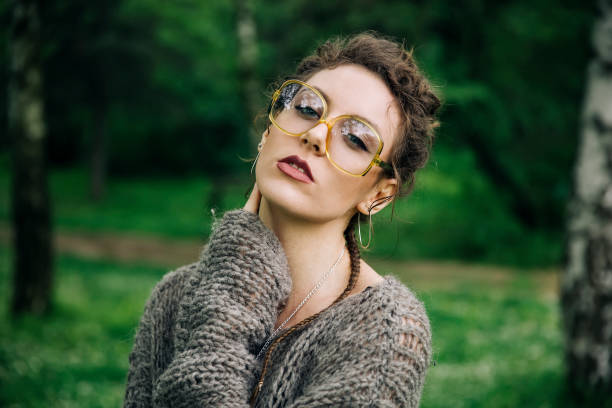 istock Pretty young woman with eyeglasses in the forest 963137740