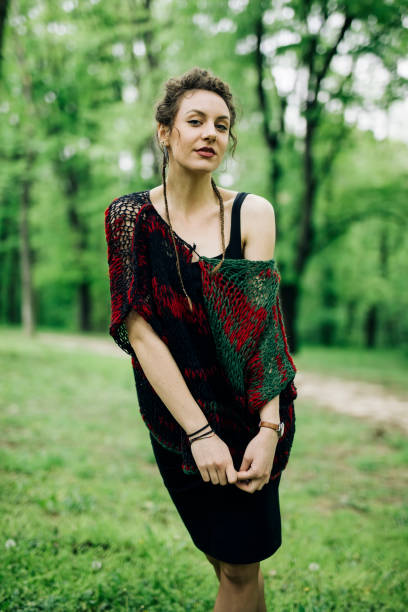 istock Young woman wearing sweater  and posing the park 963137854