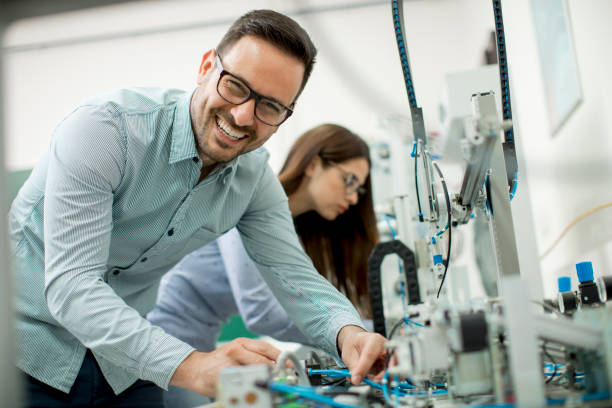 istock Young couple of students at robotics lab 963137942