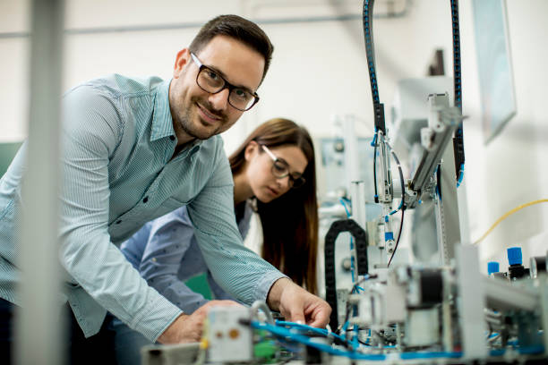 istock Young couple of students at robotics lab 963137946