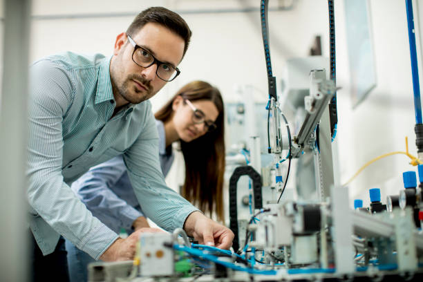istock Young couple of students at robotics lab 963137952