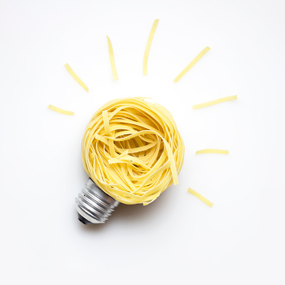 Creative concept photo of  a bulb made of pasta on white background.
