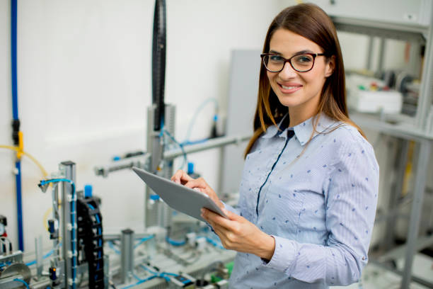 istock Young woman with digital tablet in the electronics workshop 963138330
