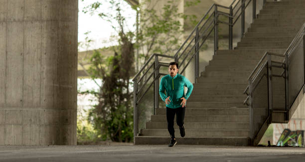 istock Young man running in urban enviroment 963138456