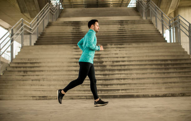 istock Young man running in urban enviroment 963138472