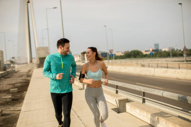 istock Young couple running in urban enviroment 963140704