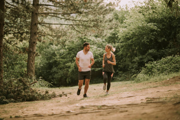 istock Couple jogging outdoors in nature 963140922