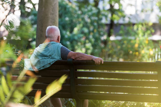 istock Senior man sitting on a bench outdoors 963141878