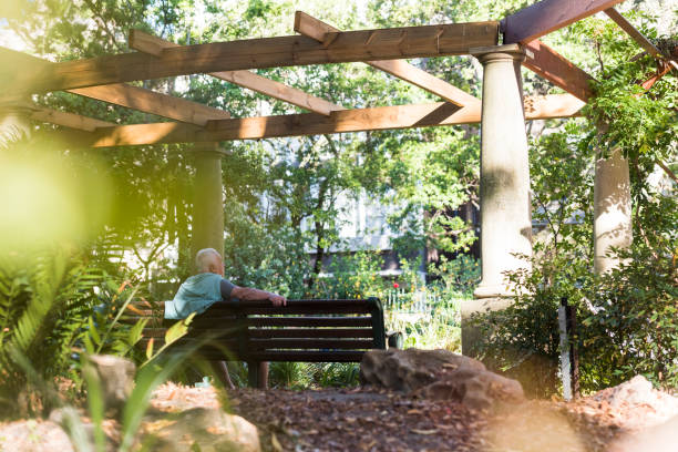 istock Senior man sitting on a bench outdoors 963141920
