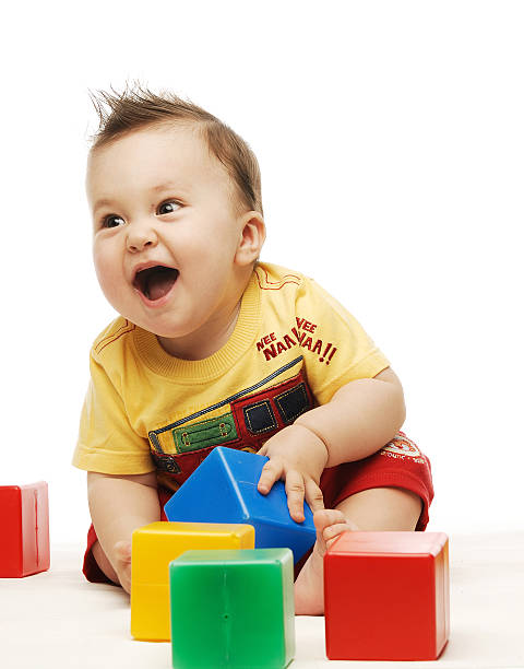 istock Baby in yellow shirt playing with bright colorful blocks 96314211