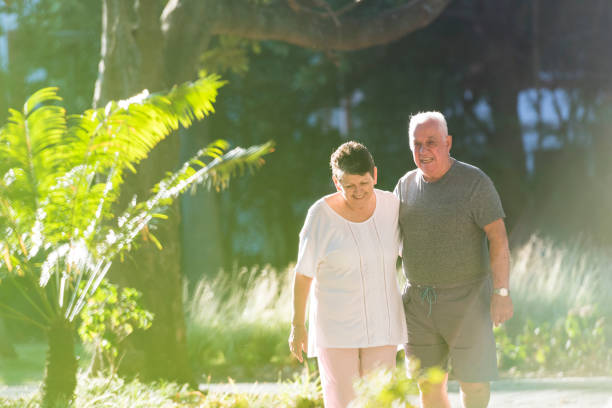istock Senior couple walking in a park 963142304