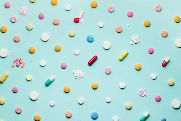 Pretty pills. A photo of different medicinal drugs, tablets and pills on blue background. antibiotic stock pictures, royalty-free photos & images