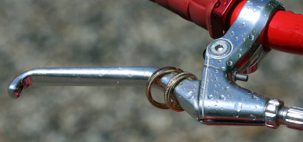 istock Rain drops and wedding rings on the brake lever of a bicycle 963145544