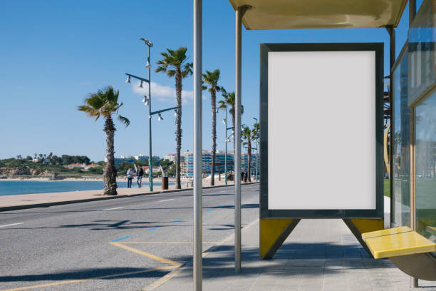 Bus stop with blank billboard Blank advertisement in a bus stop, next to the sea wind shelter stock pictures, royalty-free photos & images