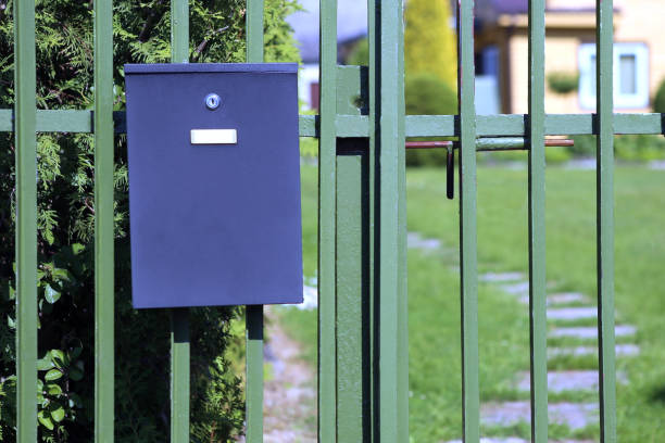 istock Mailbox hanging on fence on blurred house background. 963150396