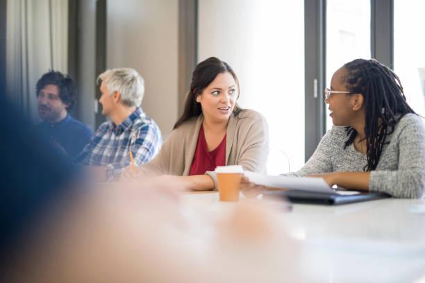 istock Multi-ethnic colleagues discussing in board room 963151968