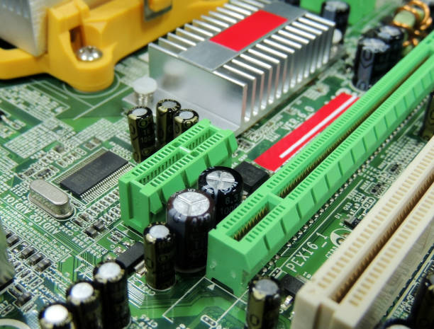 istock Computer motherboard with chip slots and soldered radio components 963156874