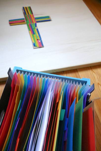 istock Colorful Crucifix lying on floor, colorful archive box in front 963157562