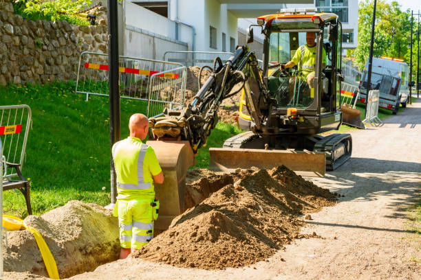Careful digging Angelholm, Sweden - May 15, 2018: Travel documentary of everyday life and place. Workers doing some careful digging with an excavator. One person in the hole to check for cables. ditch stock pictures, royalty-free photos & images