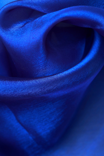 soft silk folds deep blue color - close up, decor and exclusive textured fabric background