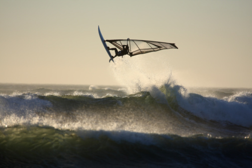 Chichester, United Kingdom – October 26, 2022: A windsurfer performing stunts in the water