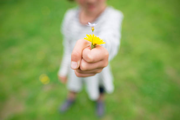 istock Girl giving flowers 963180398