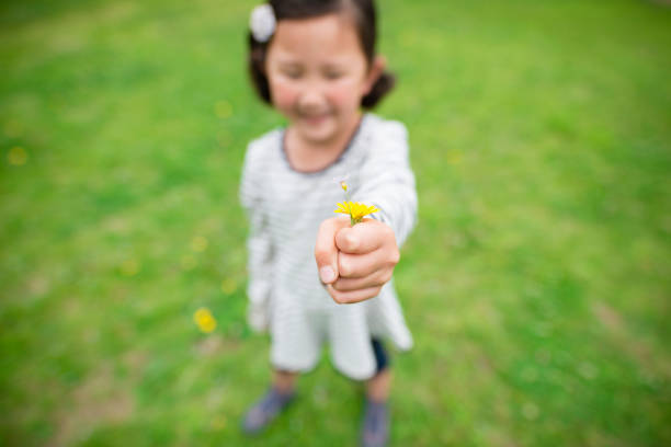 istock Girl giving flowers 963180400