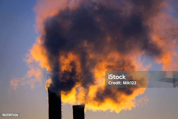 Emissions From Plant Pipe Against Setting Sun Stock Photo - Download Image Now - Greenhouse Gas, Fumes, Blue